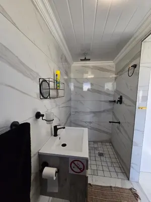 a bathroom with a sink and a shower at Aqua Breeze in Cape Town