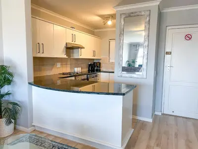 a kitchen with a large island in a room at Century Hideaway with Mountain views, Security, FREE Parking in Cape Town