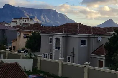 a view of houses with mountains in the background at Century Hideaway with Mountain views, Security, FREE Parking in Cape Town