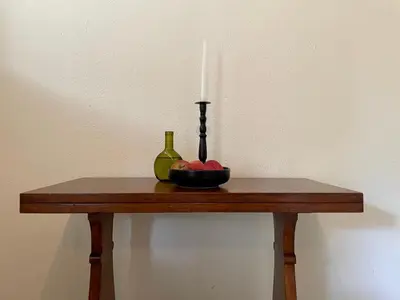 a candle and a bowl of fruit on a table at La Rose Quartier in Wellington