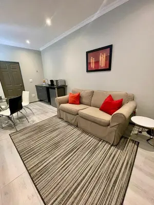 a living room with a couch and a rug at Tehillah on Boom in Bothasig