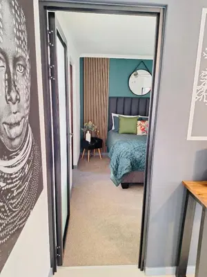 a doorway to a bedroom with a bed and a mirror at Dee-Ones at Witboom,Kenridge ,Self Catering Apartment in Kenridge