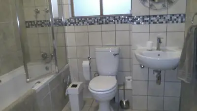 a bathroom with a toilet and a sink at Ocean Elephant Beach Apartment LONG TERM in Strand