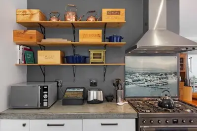 a kitchen counter with a microwave and a stove at De Boerderij in Strand