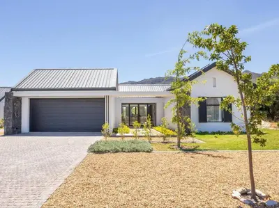 a white house with a tree in front of it at Luxury Villa 712 Pearl Valley Golf Estate in Paarl
