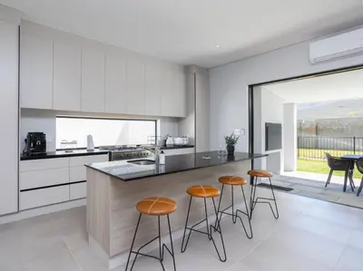 a kitchen with a counter and stools in it at Luxury Villa 712 Pearl Valley Golf Estate in Paarl