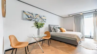 a bedroom with a bed and a table and chairs at Little island in Cape Town