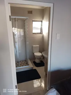 a small bathroom with a shower and a toilet at Jennings breeze in Cape Town