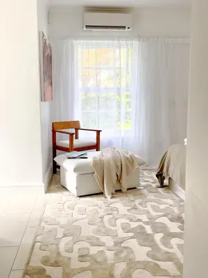 a white bedroom with a bed and a window at Duplicate in Franschhoek