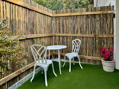 two chairs and a table and two chairs on a patio at Amsterdam Suite in Cape Town