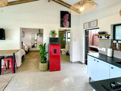 a kitchen with a red refrigerator in a room at Amsterdam Suite in Cape Town