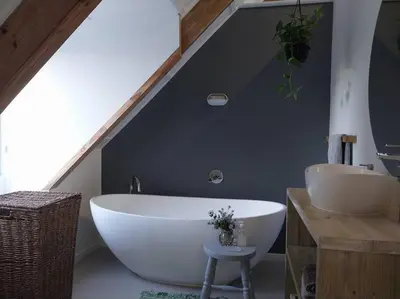a bathroom with a large white tub and a sink at Hidden gem in bush 350m from main beach in Bettyʼs Bay