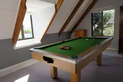 a room with a pool table in a attic at Hidden gem in bush 350m from main beach in Bettyʼs Bay