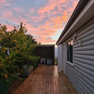 a wooden walkway leading to the side of a house at MAGNIFICENT 6 sleeper mountain getaway in Romansrivier
