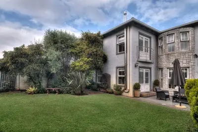 an exterior view of a house with a yard at TUSCAN VILLA FELICE near West Coast in Cape Town