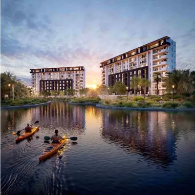 two people in kayaks on a river in front of a building at Park Place in Cape Town