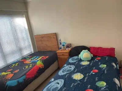 a bedroom with two twin beds and a teddy bear at Somerset West Family home holiday rental in Cape Town