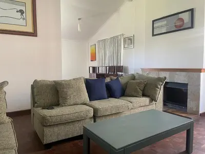 a living room with a couch and a table at House on Gill 25 in Cape Town