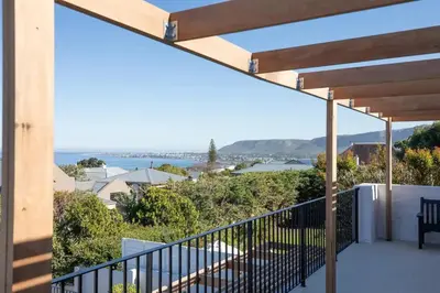 a balcony with a view of the ocean at Les Baleines Hermanus Villa in Hermanus