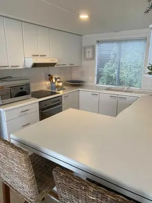 a kitchen with white cabinets and a white counter top at Moonshine in Hermanus