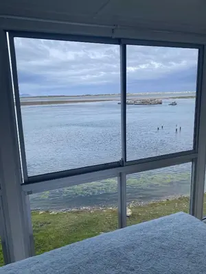 a view of the ocean from a bedroom window at Moonshine in Hermanus