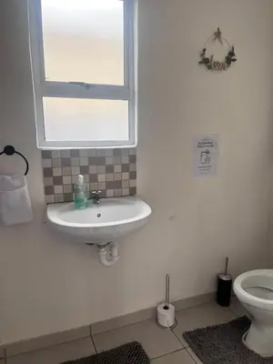 a bathroom with a sink and a toilet at Relaxa Sleep & Go - Self Catering Accommodation in Cape Town