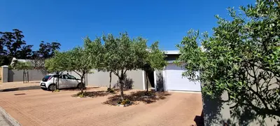 a car parked in a driveway next to a garage at C'est la Vie 2 in Franschhoek