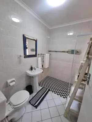 a bathroom with a toilet and a sink and a shower at Ina se Huisie in Blouberg self Catering Apartment in Cape Town