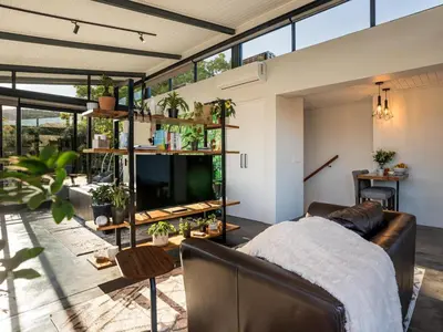 a living room with a couch and a tv at In-a-Tree in Paarl