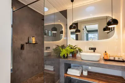 a bathroom with two sinks and a shower at In-a-Tree in Paarl