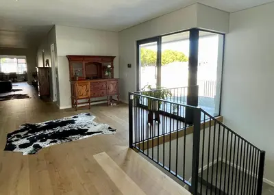 an empty living room with a staircase and a room with a window at The View in Cape Town
