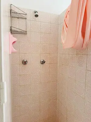 a bathroom with a shower with pink tile at Leisure Lodges Family Room Parow in Cape Town