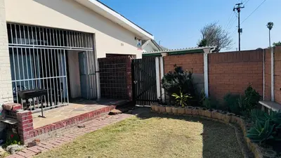 a house with a gate and a brick fence at Leisure Lodges Family Room Parow in Cape Town