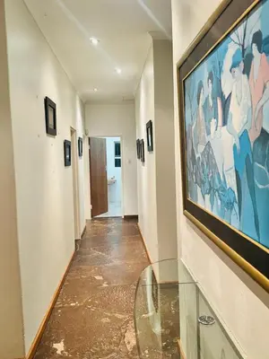a hallway with a large painting on the wall at Leisure Lodges Middle Room in Cape Town