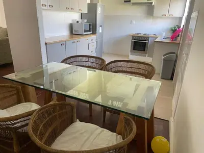a kitchen with a glass table and some chairs at Mary's Cape in Cape Town