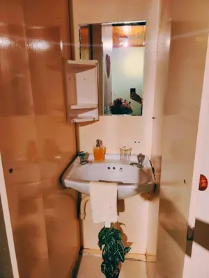 a bathroom with a sink and a mirror at Budget Haven Durbanville in Cape Town