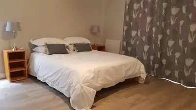 a bedroom with a white bed with two pillows at no 5 King Street, Onrus in Hermanus
