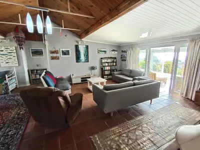 a living room with two couches and a couch at Sunset Splendour in Pringle Bay