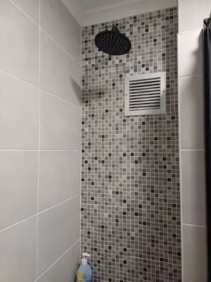 a bathroom with a shower with a vent on the wall at 24 Whale Rock Estate in Hermanus