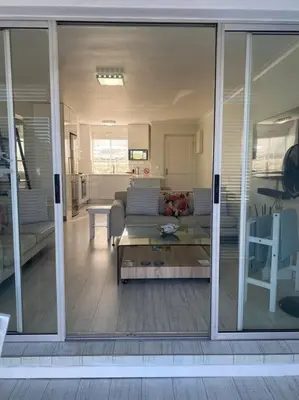 a view of a living room with sliding glass doors at 47 Whale Rock Estate in Hermanus