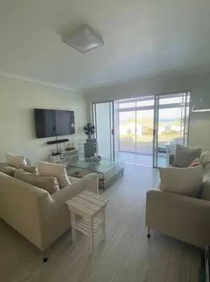 a living room with two couches and a tv at 47 Whale Rock Estate in Hermanus
