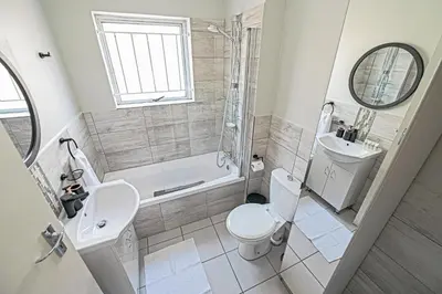 a bathroom with a toilet and a sink and a shower at Cozy Garden Unit in Bloubergstrand in Bloubergstrand