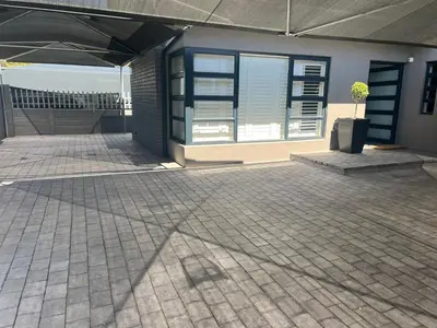 a building with a patio with a tree in it at Comfort Cove in Cape Town