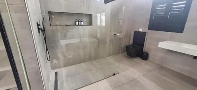 a bathroom with a shower and a toilet at Comfort Cove in Cape Town