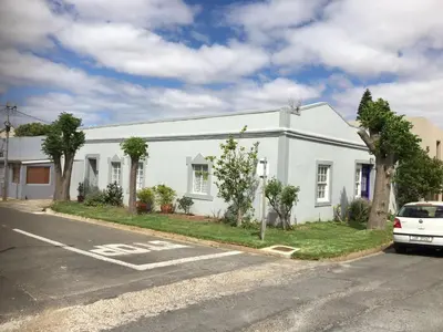 a white building on the side of a street at The Pink Door in Caledon