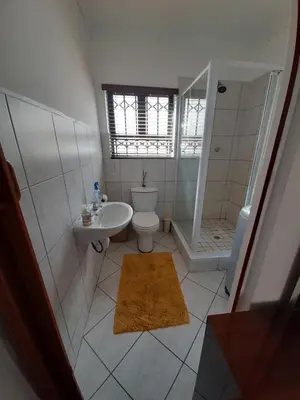 a bathroom with a toilet and a sink and a shower at Local & comfortable in Mandalay