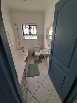 a bathroom with a toilet and a tub and a sink at Local & comfortable in Mandalay