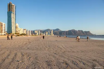 a group of people walking on a beach at NamaStay in Cape Town