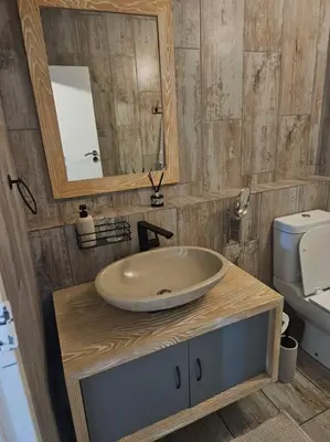 a bathroom with a sink and a mirror and a toilet at SS Luxury Apartments Island Club in Cape Town