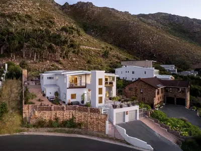 an aerial view of a house with a mountain at Phezulu Manor, Panoramic Views, Serviced Retreat in Gordonʼs Bay